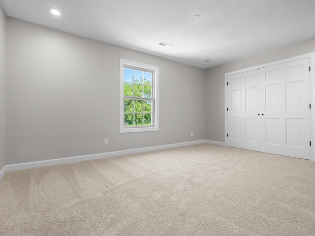 8863 Serene Acres Ln, Rogersville, MO 65742 - unfurnished bedroom with baseboards, light colored carpet, a closet, and recessed lighting