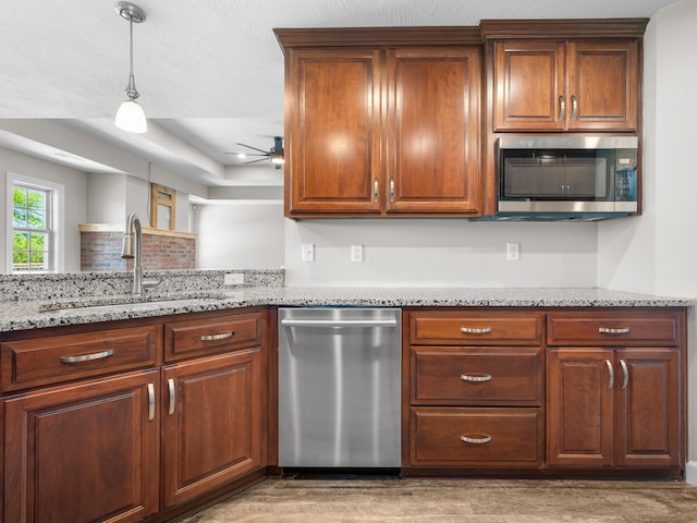 8863 Serene Acres Ln, Rogersville, MO 65742 - kitchen featuring stainless steel appliances, a sink, a ceiling fan, hanging light fixtures, and light stone counters