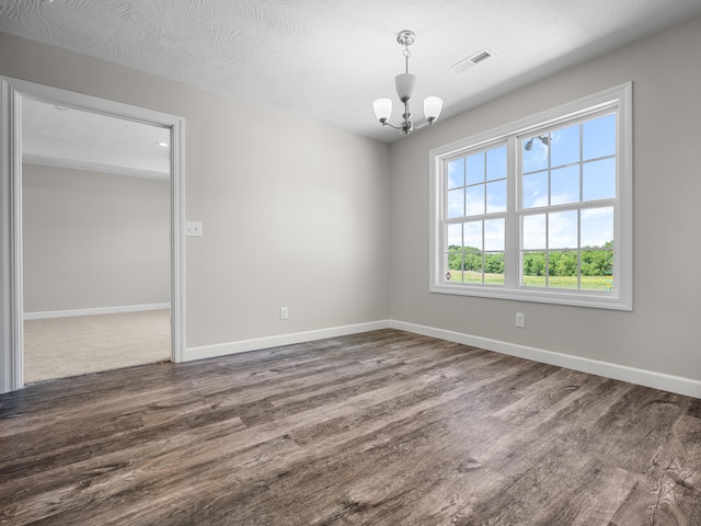 8863 Serene Acres Ln, Rogersville, MO 65742 - unfurnished room featuring wood finished floors, a chandelier, and baseboards