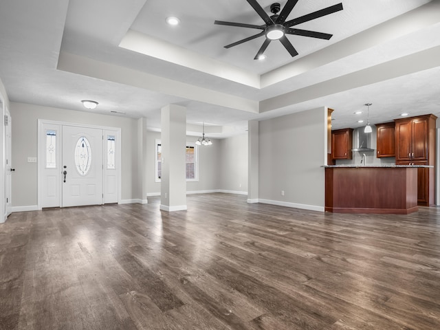 8863 Serene Acres Ln, Rogersville, MO 65742 - unfurnished living room featuring a tray ceiling, a ceiling fan, dark wood-style flooring, and recessed lighting