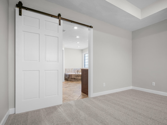 8863 Serene Acres Ln, Rogersville, MO 65742 - spare room with carpet, a barn door, recessed lighting, and baseboards