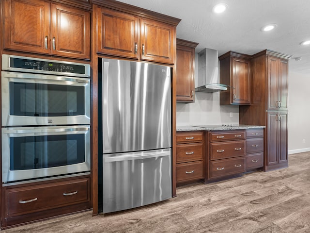 8863 Serene Acres Ln, Rogersville, MO 65742 - kitchen with stainless steel appliances, wall chimney range hood, light wood finished floors, recessed lighting, and baseboards