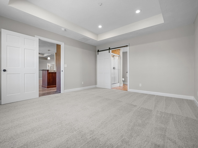 8863 Serene Acres Ln, Rogersville, MO 65742 - unfurnished bedroom featuring a raised ceiling, baseboards, light carpet, recessed lighting, and connected bathroom
