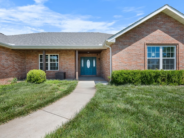 8863 Serene Acres Ln, Rogersville, MO 65742 - entrance to property with brick siding, a lawn, and roof with shingles
