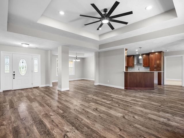 8863 Serene Acres Ln, Rogersville, MO 65742 - unfurnished living room with a raised ceiling, dark wood-style floors, a chandelier, baseboards, and recessed lighting