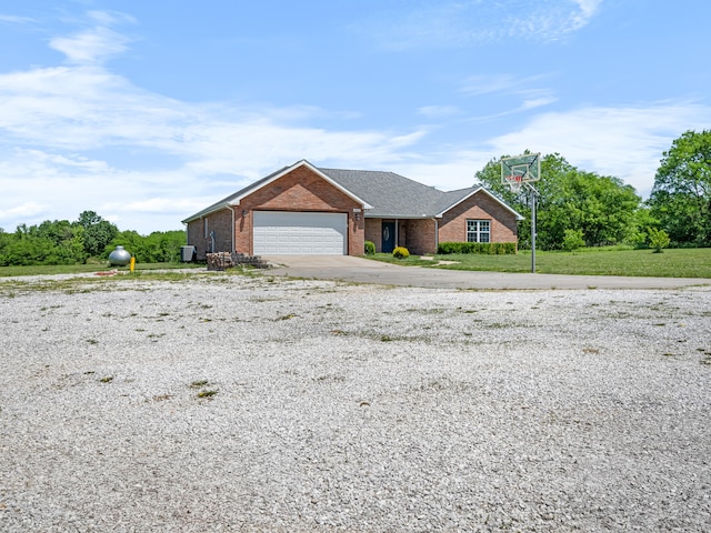 8863 Serene Acres Ln, Rogersville, MO 65742 - view of front of property with brick siding, driveway, an attached garage, and a front lawn