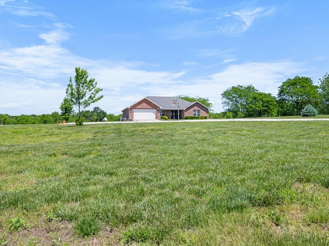 8863 Serene Acres Ln, Rogersville, MO 65742 - view of grassy yard featuring an attached garage