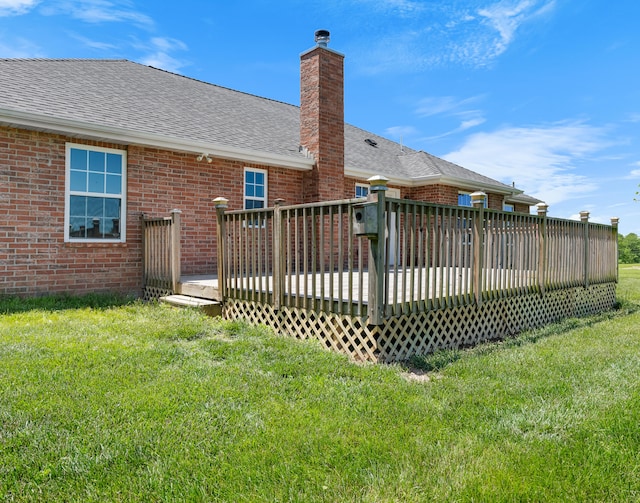 8863 Serene Acres Ln, Rogersville, MO 65742 - rear view of house with roof with shingles, brick siding, a lawn, a chimney, and a wooden deck