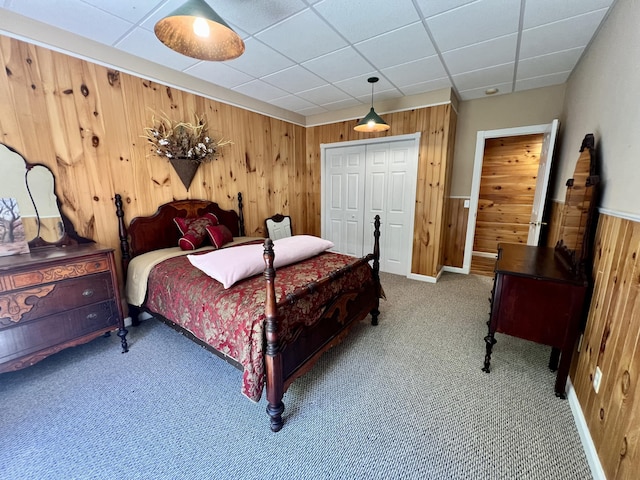 1207 Ledgestone Cir, Branson West, MO 65737 - bedroom featuring wooden walls, carpet, a closet, a drop ceiling, and baseboards
