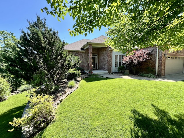 1207 Ledgestone Cir, Branson West, MO 65737 - view of front facade featuring brick siding, a front lawn, an attached garage, and driveway
