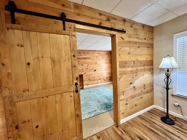1207 Ledgestone Cir, Branson West, MO 65737 - bonus room with a barn door, wooden walls, wood finished floors, and baseboards