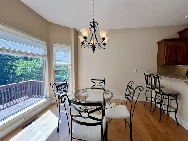 1207 Ledgestone Cir, Branson West, MO 65737 - dining room featuring light wood-type flooring, a chandelier, and baseboards