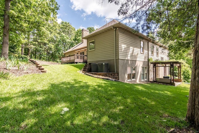 903 Silver Bluff Cir, Branson West, MO 65737 - view of property exterior featuring a chimney, a wooden deck, a lawn, and central AC