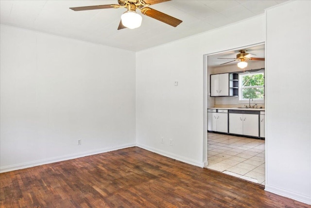 1823 W Olive St, Springfield, MO 65802 - spare room with a sink, a ceiling fan, light wood-style floors, and baseboards