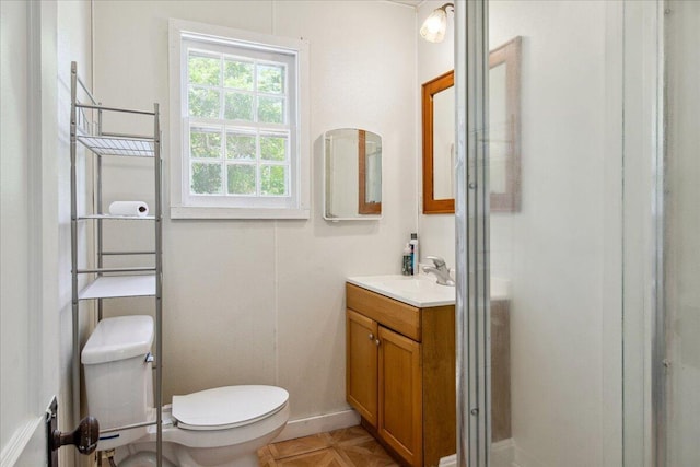1823 W Olive St, Springfield, MO 65802 - bathroom featuring toilet, vanity, a shower stall, and baseboards