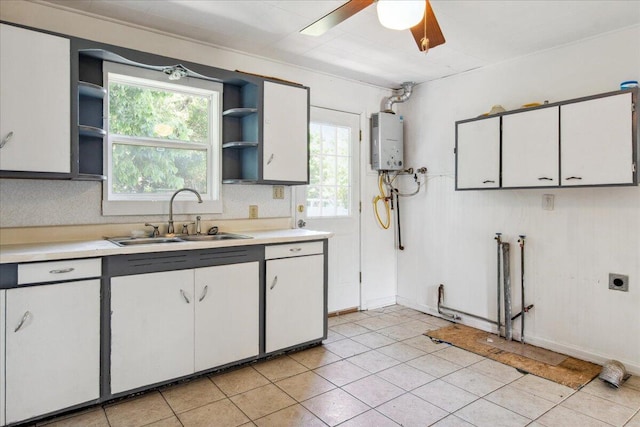 1823 W Olive St, Springfield, MO 65802 - kitchen with a sink, open shelves, water heater, light countertops, and white cabinetry