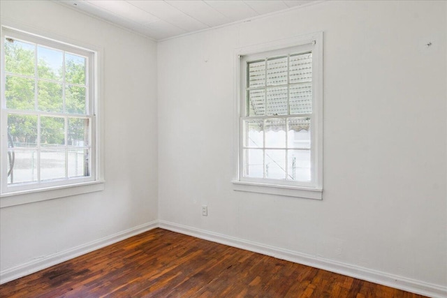 1823 W Olive St, Springfield, MO 65802 - empty room featuring plenty of natural light, dark wood-type flooring, baseboards, and ornamental molding