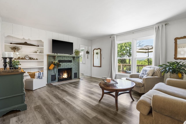 305 Cliff Dr, Branson, MO 65616 - living room featuring a brick fireplace and wood finished floors