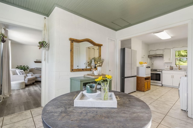 305 Cliff Dr, Branson, MO 65616 - dining area with light tile patterned flooring and washer / dryer