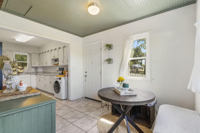 305 Cliff Dr, Branson, MO 65616 - kitchen with washer / dryer, white cabinets, and light countertops
