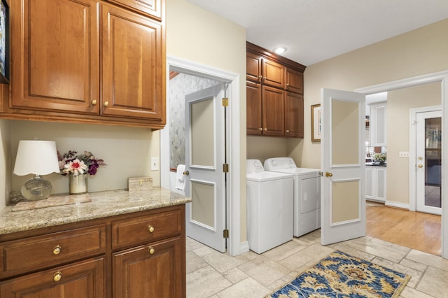 5575 S Castlebay Dr, Springfield, MO 65809 - laundry area featuring cabinet space, washer and clothes dryer, baseboards, stone tile flooring, and recessed lighting