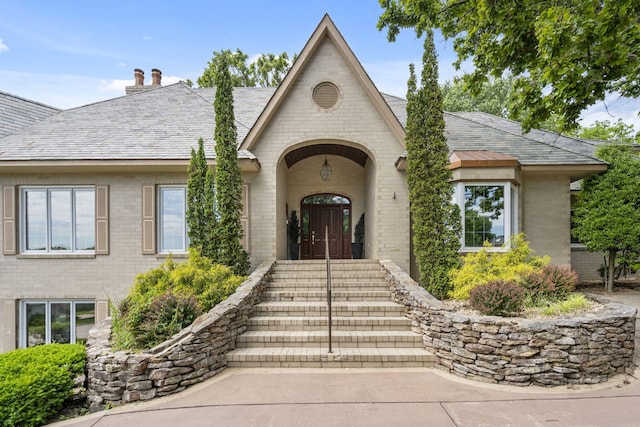 5575 S Castlebay Dr, Springfield, MO 65809 - entrance to property featuring brick siding and a chimney