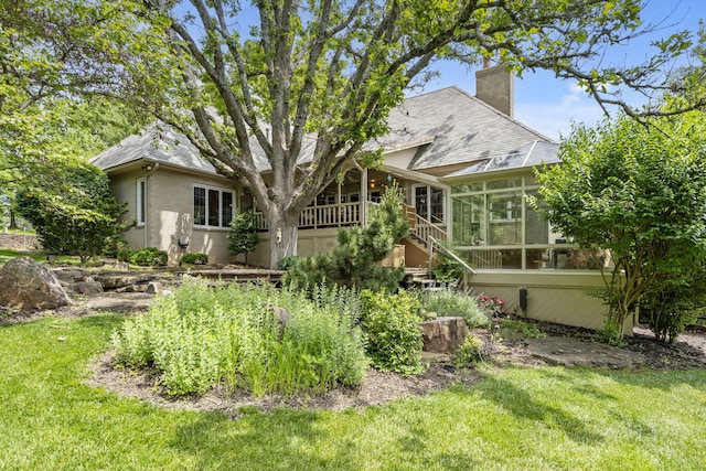 5575 S Castlebay Dr, Springfield, MO 65809 - rear view of house featuring a sunroom, a chimney, a lawn, and a shingled roof
