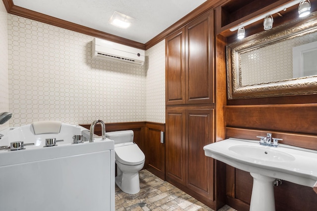5575 S Castlebay Dr, Springfield, MO 65809 - bathroom featuring ornamental molding, a wall unit AC, wallpapered walls, toilet, and a bath