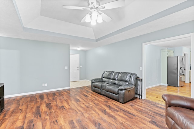 3645 S Ridgecrest Ave, Springfield, MO 65807 - living area with a raised ceiling, hardwood / wood-style flooring, ceiling fan, and baseboards