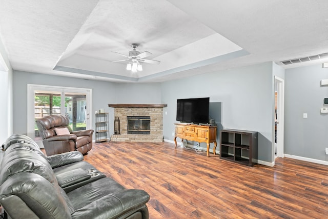 3645 S Ridgecrest Ave, Springfield, MO 65807 - living area with a raised ceiling, baseboards, wood finished floors, ceiling fan, and a glass covered fireplace