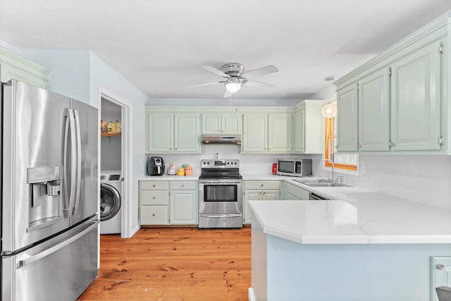 3645 S Ridgecrest Ave, Springfield, MO 65807 - kitchen with stainless steel appliances, washer / clothes dryer, under cabinet range hood, a sink, and a peninsula