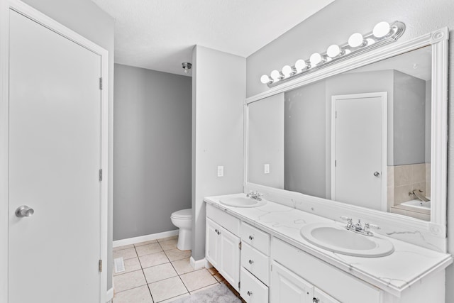 3645 S Ridgecrest Ave, Springfield, MO 65807 - full bathroom featuring double vanity, toilet, tile patterned floors, a garden tub, and baseboards