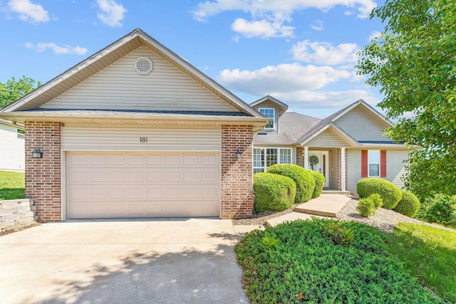 181 Rosewood Ln, Branson, MO 65616 - view of front of home with brick siding, concrete driveway, and an attached garage