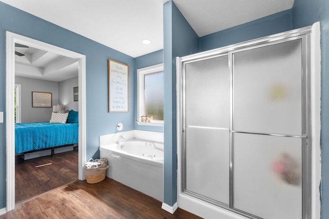 181 Rosewood Ln, Branson, MO 65616 - bathroom with ensuite bath, wood finished floors, a bath, and a stall shower
