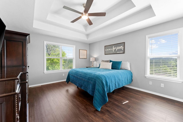 181 Rosewood Ln, Branson, MO 65616 - bedroom featuring a tray ceiling, baseboards, dark wood finished floors, and a ceiling fan