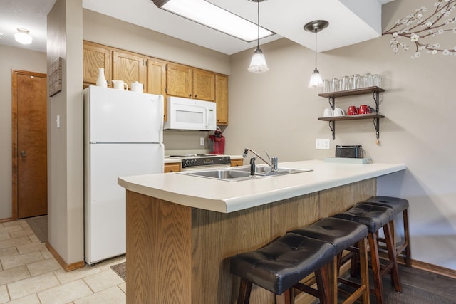 437 Notch Ln Unit 8, Branson West, MO 65737 - kitchen featuring white appliances, a sink, a peninsula, baseboards, and a kitchen bar