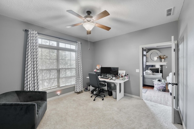 3192 W Melbourne St, Springfield, MO 65810 - home office featuring carpet flooring, a ceiling fan, a fireplace, and baseboards