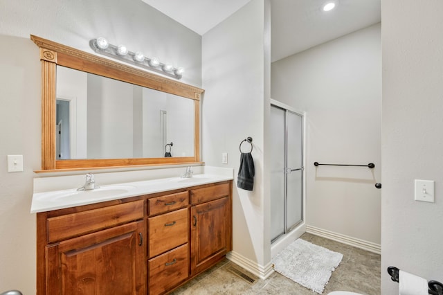 3192 W Melbourne St, Springfield, MO 65810 - bathroom featuring a shower stall, double vanity, and baseboards