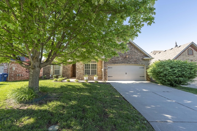 3192 W Melbourne St, Springfield, MO 65810 - obstructed view of property featuring concrete driveway, an attached garage, a front lawn, and brick siding