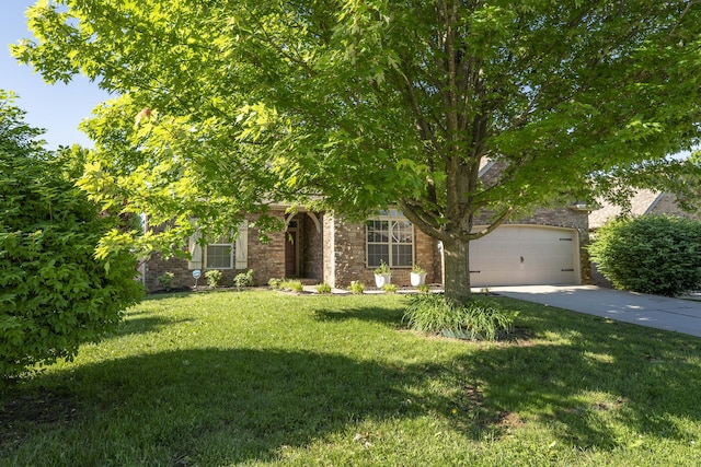 3192 W Melbourne St, Springfield, MO 65810 - obstructed view of property with driveway, a front yard, an attached garage, and brick siding