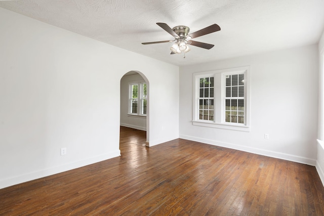 2500 W Mount Vernon St, Springfield, MO 65802 - spare room featuring arched walkways, a ceiling fan, baseboards, and wood finished floors