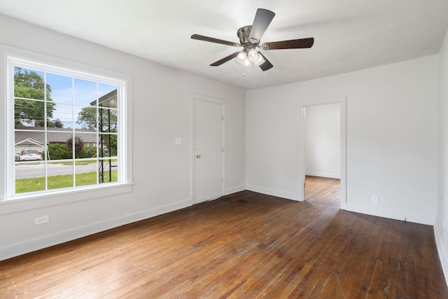 2500 W Mount Vernon St, Springfield, MO 65802 - spare room with wood-type flooring, baseboards, and a ceiling fan