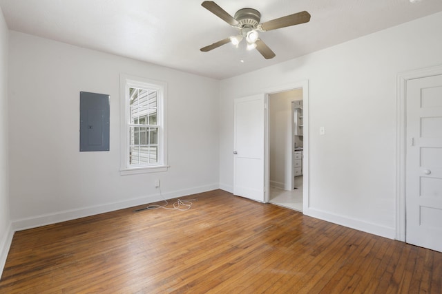 2500 W Mount Vernon St, Springfield, MO 65802 - unfurnished bedroom featuring electric panel, light wood-style flooring, baseboards, and a ceiling fan