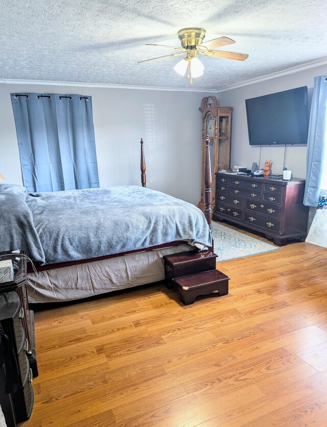204 E College St, Walnut Grove, MO 65770 - bedroom featuring wood finished floors, ornamental molding, a textured ceiling, and a ceiling fan