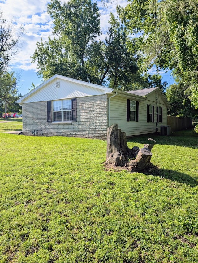 204 E College St, Walnut Grove, MO 65770 - view of front facade featuring central AC, a front lawn, and brick siding