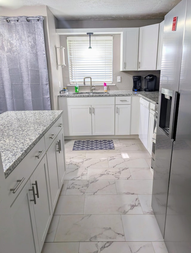 204 E College St, Walnut Grove, MO 65770 - kitchen with stainless steel fridge, a sink, light marble finish floors, and white cabinets