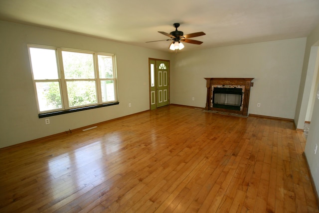 360 Banning St, Marshfield, MO 65706 - unfurnished living room featuring a fireplace with flush hearth, ceiling fan, hardwood / wood-style flooring, and baseboards