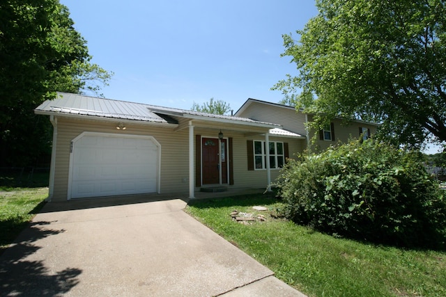 360 Banning St, Marshfield, MO 65706 - view of front of property with a garage, concrete driveway, metal roof, and covered porch