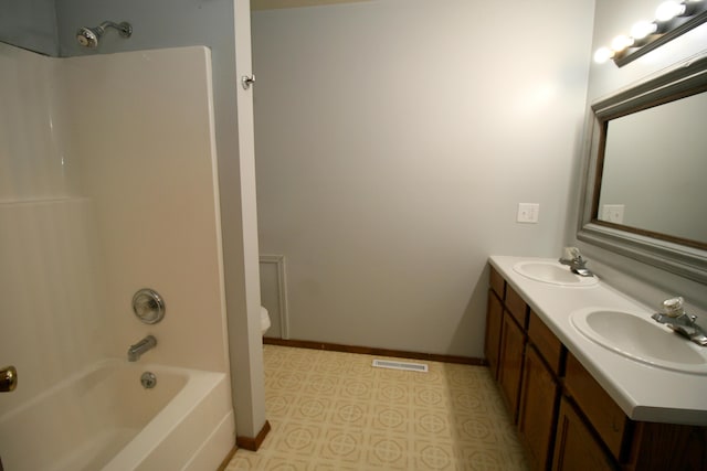360 Banning St, Marshfield, MO 65706 - full bathroom featuring double vanity, washtub / shower combination, baseboards, tile patterned floors, and toilet