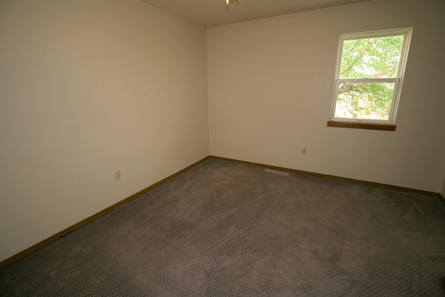 360 Banning St, Marshfield, MO 65706 - spare room featuring baseboards, dark carpet, and a ceiling fan